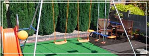 Image of a playground with artificial grass